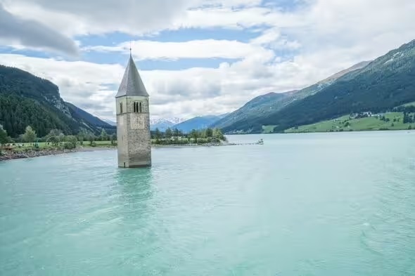 Beautiful Italian lake hides a mysterious abandoned town with only a tower visible